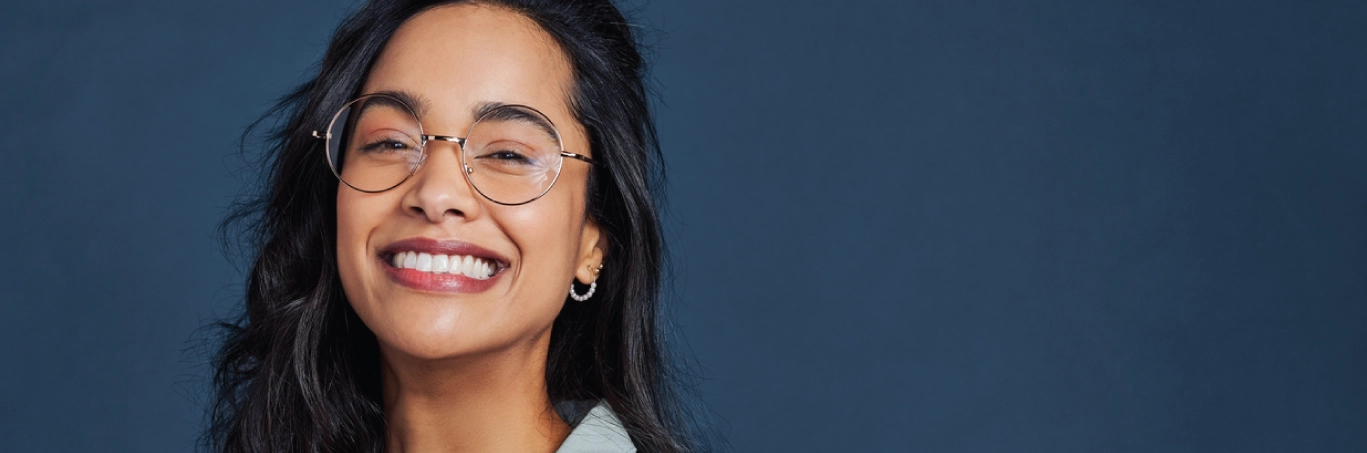 Young woman smiling while wearing glasses